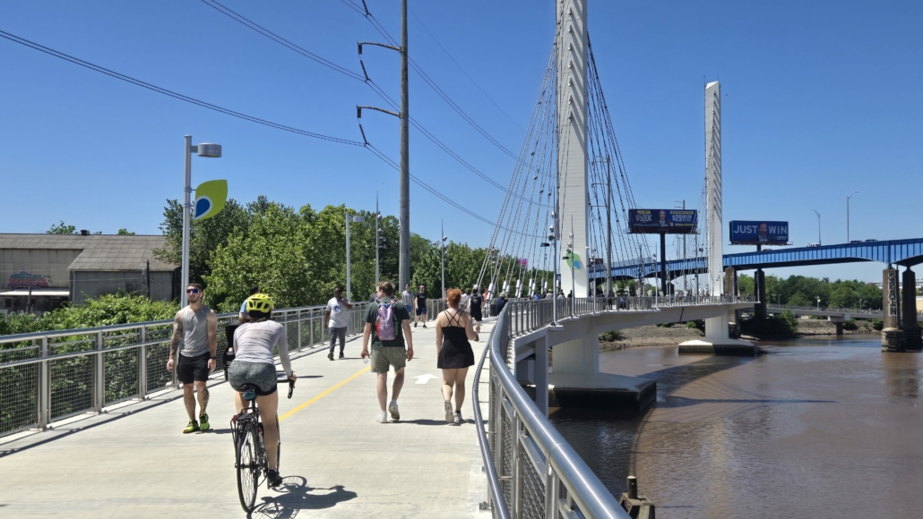 group of people walking, running and riding bikes on the Christian to Crescent cable-stayed pedestrian bridge