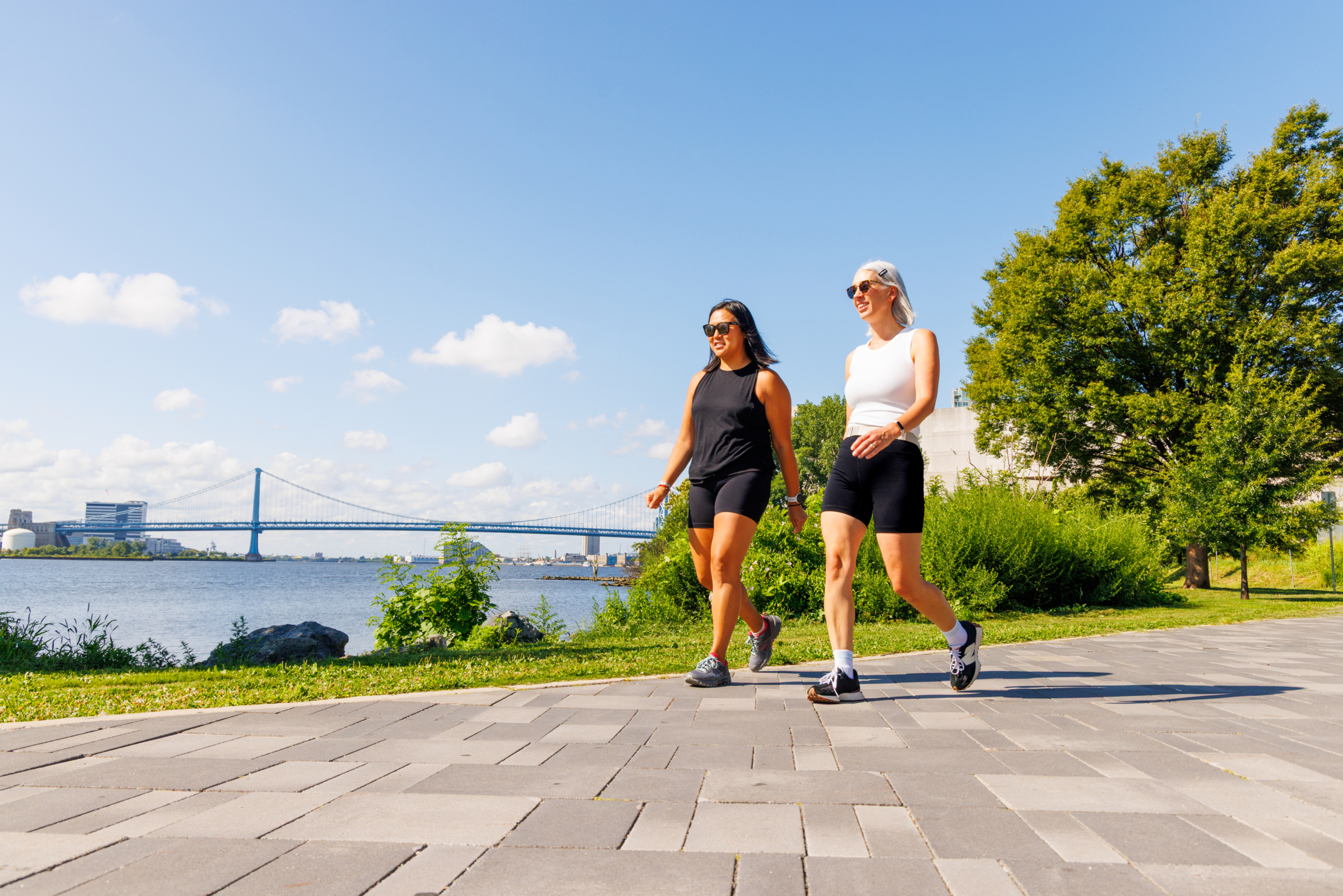 Two women walking on the Delaware River Trail
