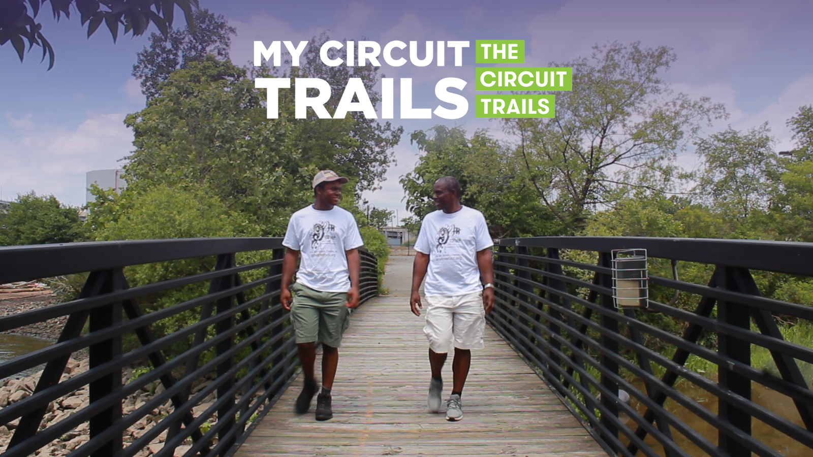 father and son walking along a pedestrian bridge on the Chester Riverfront Trail