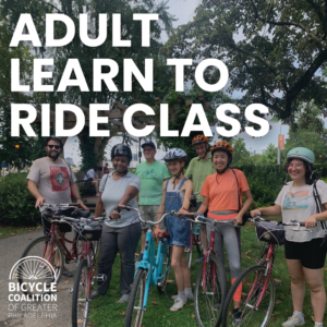 Group of adults posing with bikes