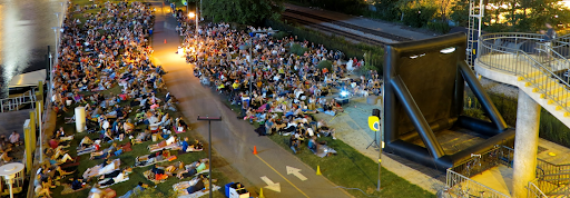 people lined up watching a movie outside on the Schuylkill River Trail